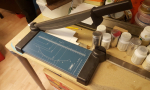 For cutting square pieces ordinary low-tech works just fine. First picture  shows my manual cutter I had for years. Really can recommend something like it, it cuts perfect straight edges in both hard-card and styrene (up to 0.75mm). Second photo shows ...