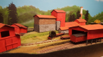 Since last I have painted and ballasted the standard gauge in the back. Also put on roofs and painted the three side-buildings. When this was done it was time to put attention back to the front and concentrate on the cableway station on the foundry side.