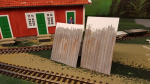 The roofs of these buildings were not covered with tiles but instead corrugated iron sheets were used. Tiles were more for permanent buildings. Also, I would not be the one climbing up on a ladder to change tiles that high up .... I took some hardcard ...