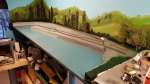 Pier in place and first ground paint is added all over, to get a better sense of whats to come. The water will get several coats on top of this. Now the harbor has room for a lot vessels floating around the dock, with tiny 18in trains running around and